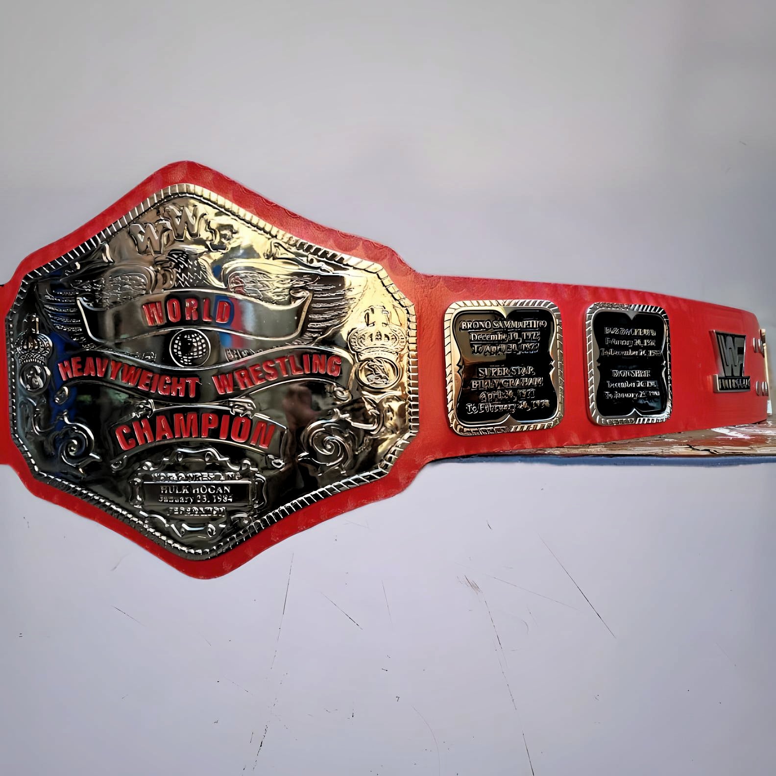 The red nickel strap and center plate of the Hulk Hogan 1984 WWF Championship Belt.