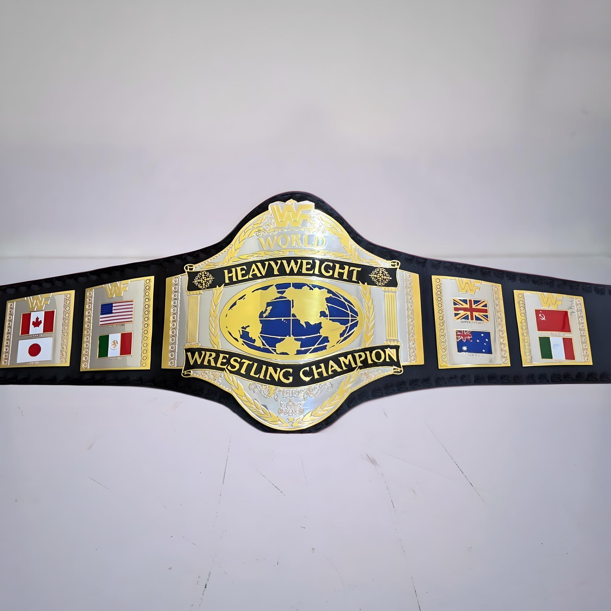 Close-up view of detailed engravings and textures on Hulk Hogan’s 1986 WWF championship belt.
