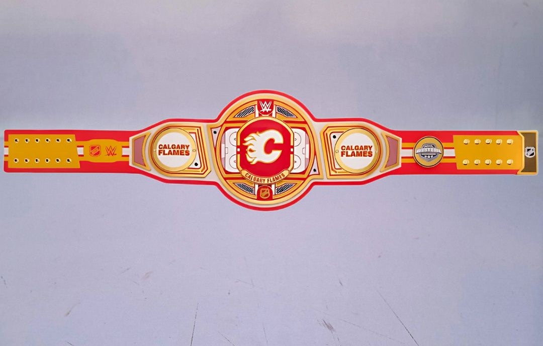 Detailed view of the WWE Championship Belt for the Calgary Flames, featuring embossed logos and a polished finish.