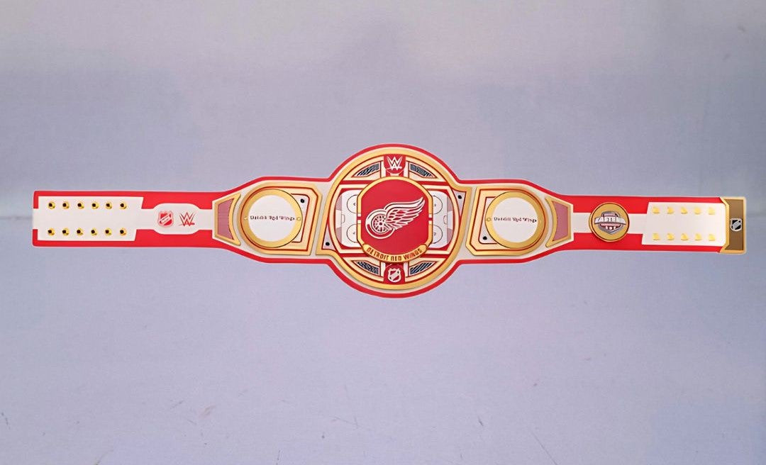 Detailed view of the Detroit Red Wings WWE Championship Belt, featuring embossed logos and a polished finish.