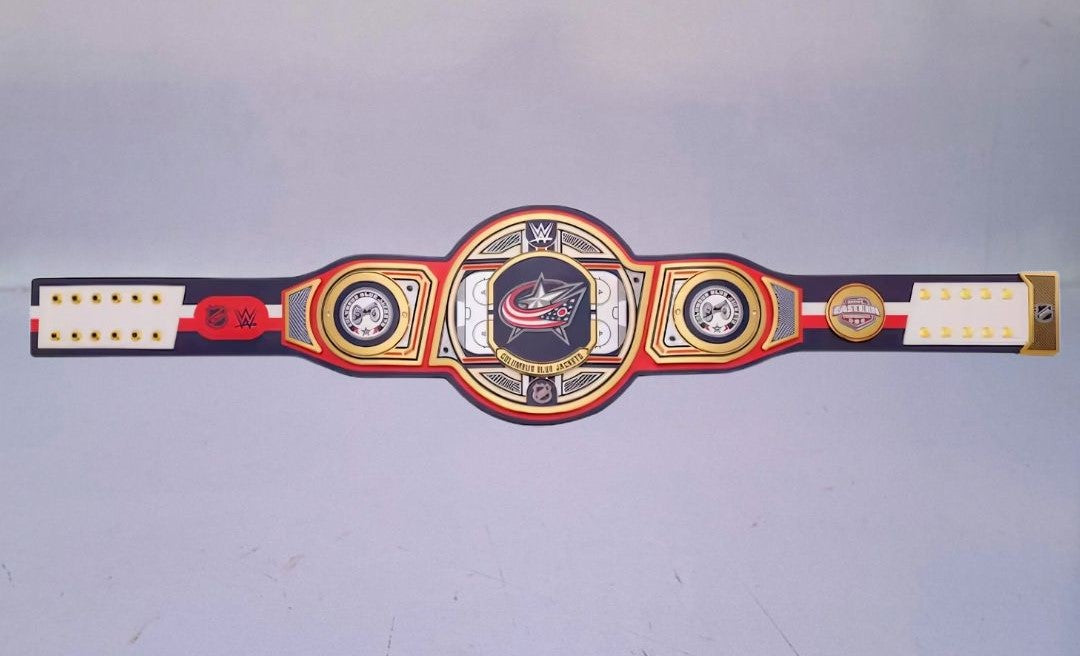 Detailed view of the Columbus Blue Jackets WWE Championship Belt, featuring embossed logos and a polished finish.